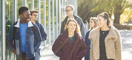 Students walking in the sunshine.