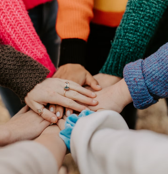 Undergraduate students holding hands