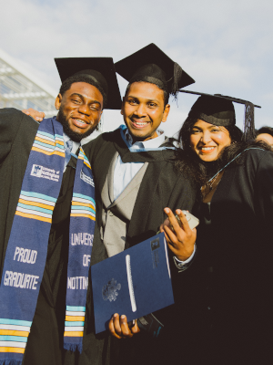 Three international students celebrating graduation