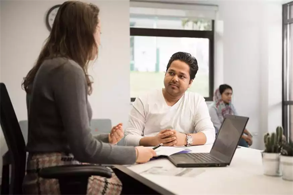 Postgraduate students talking and studying