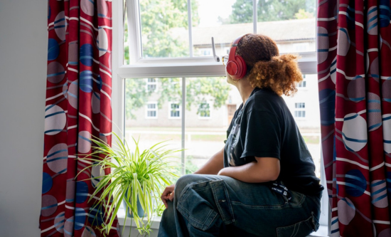 Student looking out of window at Hall